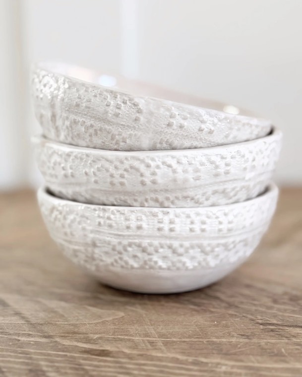 A stack of hand-glazed textured ceramic bowls