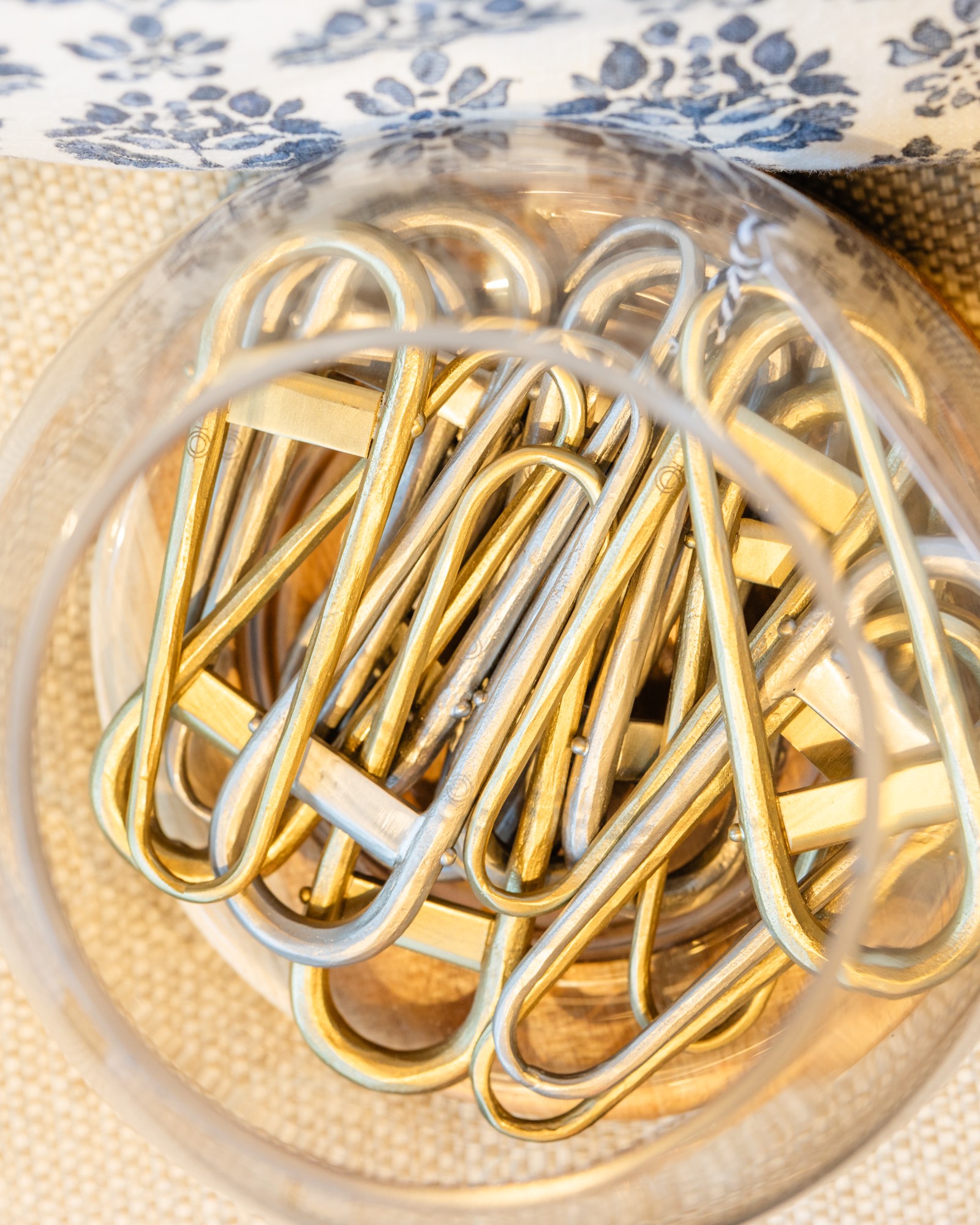Brass clothespins in a glass jar